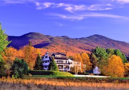 a large house in front of a mountain at Franconia Inn in Franconia