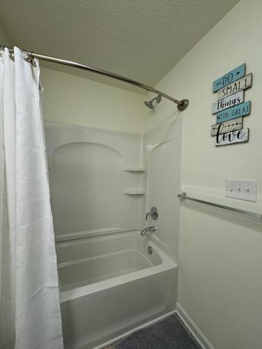 a bathroom with a bath tub and a shower curtain at Townhouse Bridgeport Close UHC,FBI,Bridge complex in Bridgeport