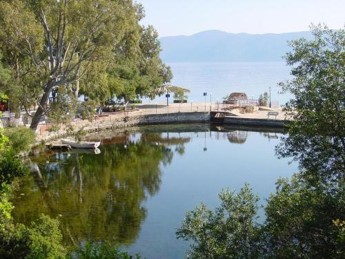 a body of water with trees and a bridge at stunning tranquil villa with private pool in Sami