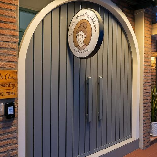 a gate with a sign on it in a building at C Chau Apartment in Ho Chi Minh City