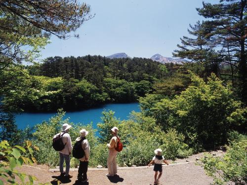 a group of people standing in front of a lake at Hotel Green Selec in Sendai
