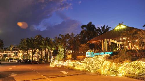 a parking lot with christmas lights in front of a building at Felix River Kwai Resort - SHA Plus,Certified in Kanchanaburi