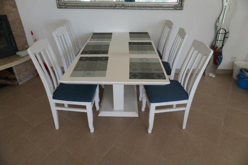 a table and chairs with a chess board on it at Vila Brca in Brca