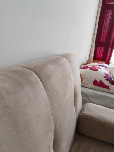 a couch sitting in a living room next to a chair at Партерни студия без обособен балкон ул Т Светослав и ул българия in Pomorie