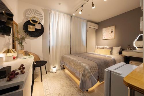 a small bedroom with a bed and a desk at Hotel-Like Simmons Bed Couple Disney Shinjuku in Tokyo
