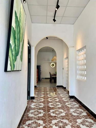 a hallway with a tile floor and a painting on the wall at SeaSpace Homestay in Phú Hiệp