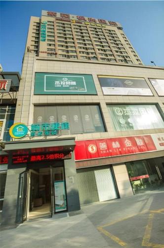 a tall building with signs on the side of it at City Comfort Inn Hotel Wuhan Optics Valley Square Metro Station Zhongnan Minzu University in Wuhan