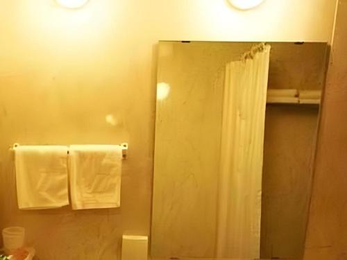 a bathroom with a mirror and white towels at Jinjiang Inn Shenyang Northeastern University in Shenyang