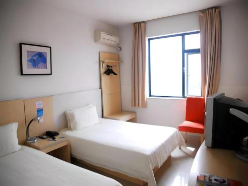 a hotel room with two beds and a television at Jinjiang Inn Shaoxing Shengli West Road Luxun Hometown in Shaoxing