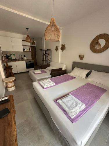 a bedroom with a large bed with purple sheets at VMJ side sea view in Perea
