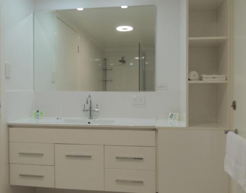 a bathroom with a sink and a mirror at Park View Motel in Gladstone