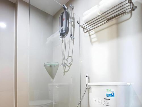 a hospital room with a toilet and a glass wall at B2 Udon Thani Boutique and Budget Hotel in Udon Thani