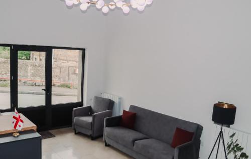 a living room with a couch and a chair at Shushabandi Kazbegi in Stepantsminda