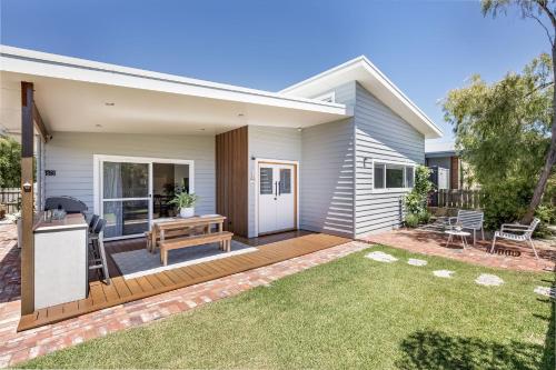 a house with a deck and a backyard at LJ's Hideout in Dunsborough