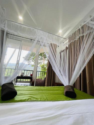 a bedroom with a white bed with a window at Ella Hillcrest Heaven-Free Pickup from Ella in Ella