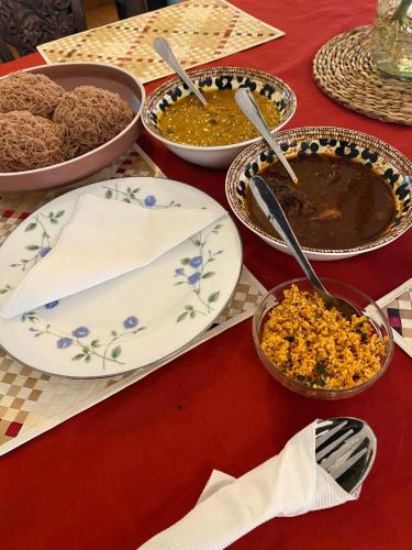 a table topped with plates and bowls of food at The Curry Lodge - Thimbiriya in Habaraduwa