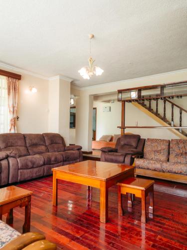 a living room with a couch and a coffee table at Solio Gardens Nanyuki in Nanyuki