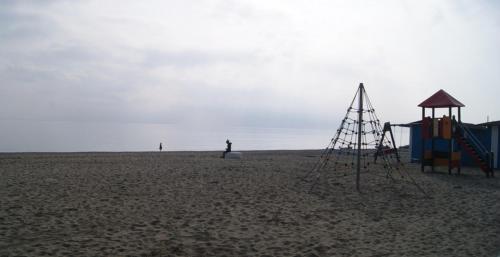a playground on a beach with a person in the background at Hotel Doña Luisa in San Luis de Sabinillas