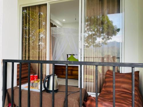 a room with a balcony with a chair and a window at Ella Hillcrest Heaven-Free Pickup from Ella in Ella