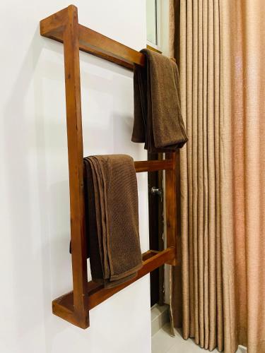 a wooden towel rack on a wall with towels at Ella Hillcrest Heaven-Free Pickup from Ella in Ella