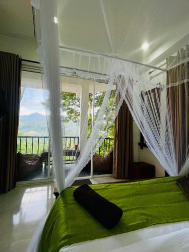 a bedroom with a green bed with curtains and a balcony at Ella Hillcrest Heaven-Free Pickup from Ella in Ella