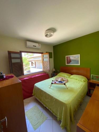 a bedroom with a bed and a green wall at Village Japara in Ilhéus