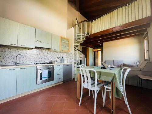 a kitchen with a table and chairs in a kitchen at MaGio House in Iseo