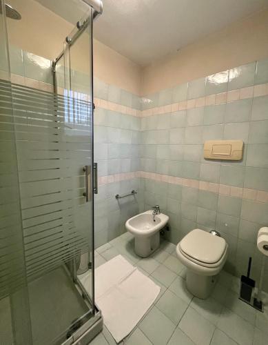 a bathroom with a toilet and a sink at MaGio House in Iseo