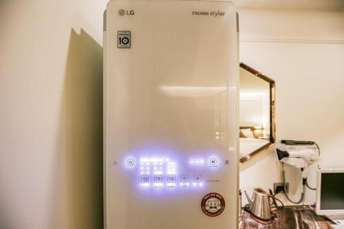 a white appliance with lights on it in a room at Cheongju Maryjane Hotel in Cheongju