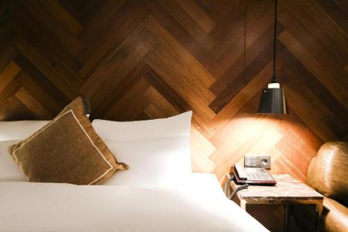 a bedroom with a bed with a wooden wall at Cheongju Maryjane Hotel in Cheongju