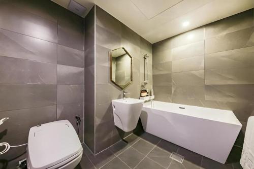 a bathroom with a white toilet and a sink at Cheongju Maryjane Hotel in Cheongju