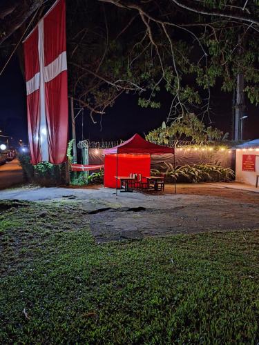 a red tent in a park at night at Nordico Hotel y Restaurante in Montenegro