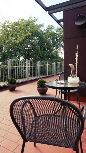 a table and a chair on a patio at Hotel Babilonas in Kaunas