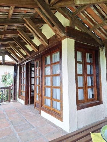 a house with wooden windows and a wooden ceiling at Nordico Hotel y Restaurante in Montenegro