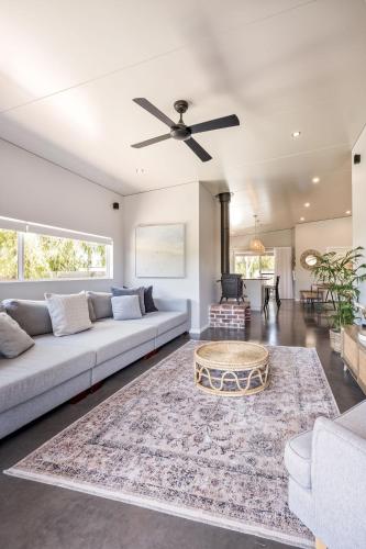 a living room with a couch and a ceiling fan at LJ's Hideout in Dunsborough