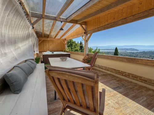 an outdoor patio with a table and chairs and a couch at Viros Holiday House Breathtaking Views & Private Mini Pool Jacuzzi in Corfu in Virós