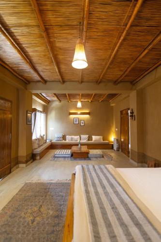 a large room with a couch and a table at Hoongla Inn - Homestay in Lumla Tawang in Kāmbāng