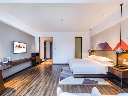 Ένα ή περισσότερα κρεβάτια σε δωμάτιο στο Borrman Hotel Nanning Railway Station