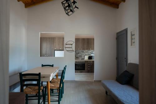 a kitchen and dining room with a table and chairs at Luxury Central Beach House in Kithnos