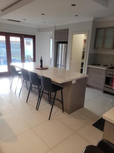 a kitchen with a table and chairs in a room at The Mount Martha Hideaway in Mount Martha