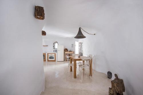 a kitchen and dining room with a table and chairs at Anemoscope Windmill Villa in Pirgos