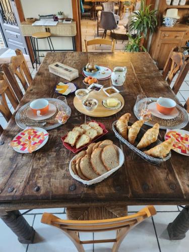 a wooden table with plates of food on it at Ferme de la Forterie in Verlinghem