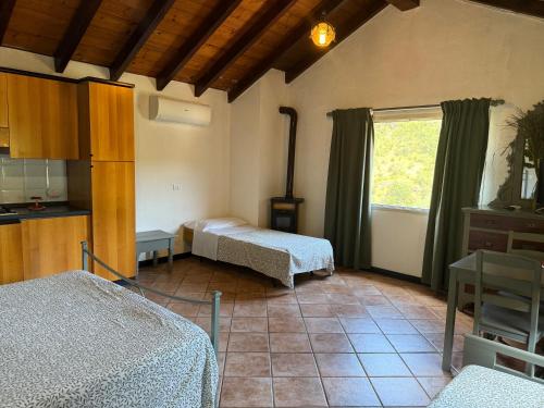 a room with two beds and a window at Agriturismo Argentea in Arenzano