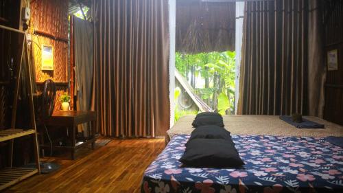 a bedroom with a bed with pillows on it at Saigon Garden Homestay in Ho Chi Minh City