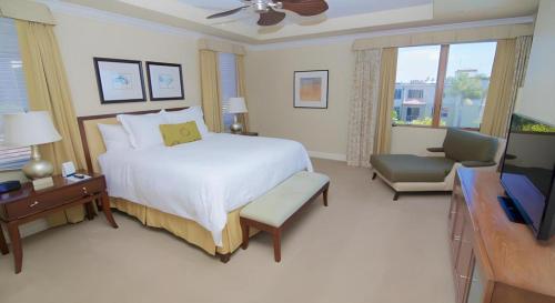 a bedroom with a large bed and a television at Dolphin Bay Resort and Spa in Pismo Beach