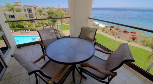 a table and chairs on a balcony with a view of the ocean at Dolphin Bay Resort and Spa in Pismo Beach