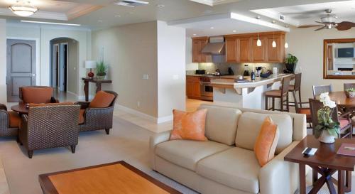 a living room with a couch and a kitchen at Dolphin Bay Resort and Spa in Pismo Beach