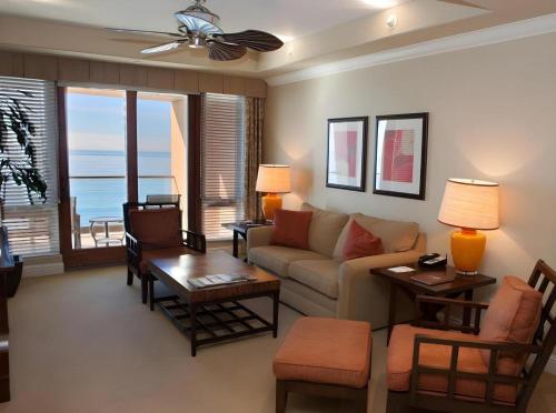 a living room with a couch and a table at Dolphin Bay Resort and Spa in Pismo Beach