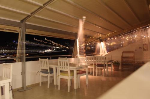 a dining room with a table and chairs on a balcony at The White House Kalkan in Kalkan
