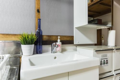 a kitchen with a white sink in a kitchen at Samurai House - Large Family House, West Shinjuku in Tokyo